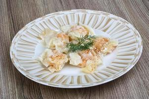 Shrimp wanton on the plate and wooden background photo