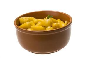 Marinated pepper in a bowl on white background photo