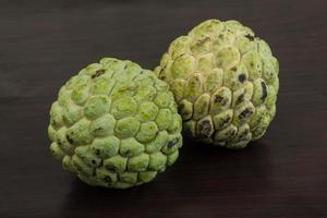 Custard apple on wooden background photo