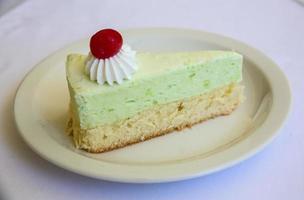Pistachio cheesecake on white background photo