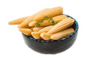 Baby corn in a bowl on white background photo