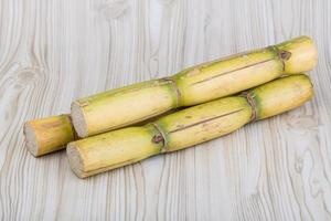 Sugar reed on wooden background photo