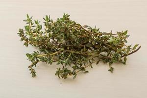 Thyme on wooden background photo