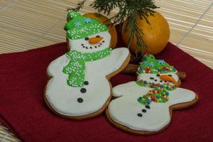 Christmas gingerbread on wooden background photo