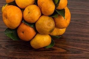 Tangerine on wooden background photo