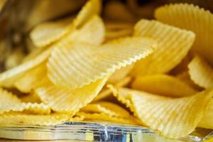 Potato chips in open snack bag close up photo