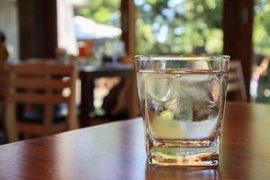 glass of water on wood table in restaurant photo