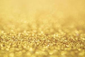 Abstract Gold glitter festive Christmas texture background blur with bokeh light photo