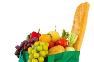 Fresh fruits and vegetables grocery product in green reusable shopping bag isolated on white background with clipping path photo