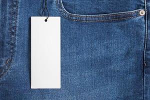 Blue jeans with blank white price label tag photo