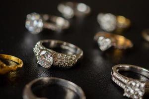 Jewelry diamond rings set on black background close up photo