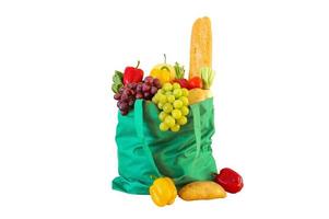 Fresh fruits and vegetables grocery product in green reusable shopping bag isolated on white background with clipping path photo