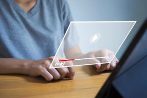 A woman is using a laptop to stream online. Watch videos on the Internet, live concerts, performances. photo