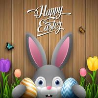 Happy easter with rabbit holding two egg colorful on wooden brown background vector