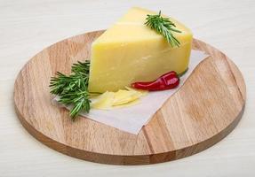 queso parmesano sobre tablero de madera y fondo de madera foto