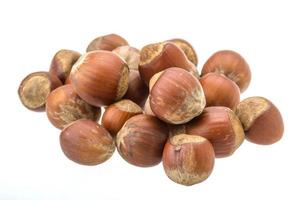 Hazelnut heap on white background photo