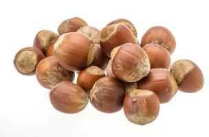 Hazelnut heap on white background photo