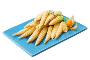 Baby corn on the plate and white background photo