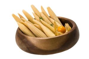 Baby corn in a bowl on white background photo