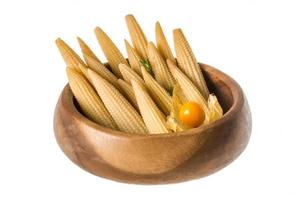 Baby corn in a bowl on white background photo