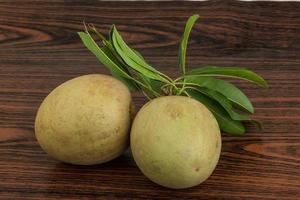 Sapodilla on wooden background photo