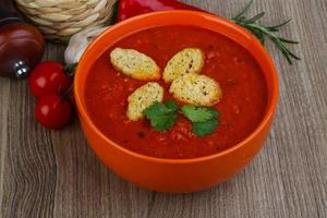 Gazpacho in a bowl on wooden background photo