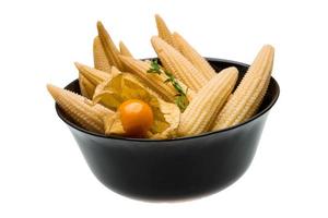 Baby corn in a bowl on white background photo