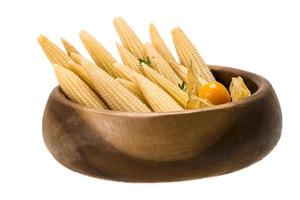 Baby corn in a bowl on white background photo