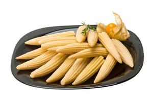 Baby corn on the plate and white background photo