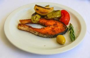 Grilled salmon on the plate and white background photo