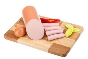 Sausages on wooden board and white background photo