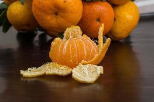 Tangerine on wooden background photo