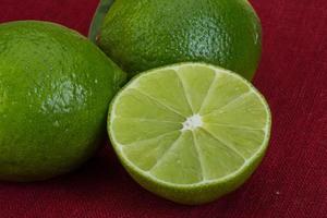 Fresh lime on red background photo