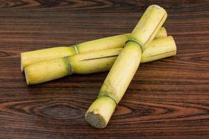 Sugar reed on wooden background photo