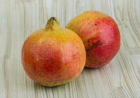 Yellow Pomegranet on wooden background photo