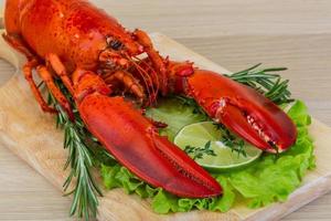 Boiled lobster on wooden board and wooden background photo