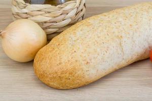 Fresh baguette on wooden background photo