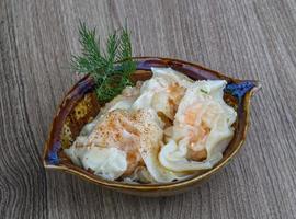 Shrimp wanton in a bowl on wooden background photo