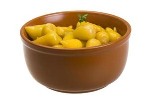 Marinated pepper in a bowl on white background photo