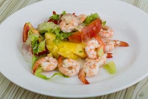 Shrimps with aloe vera salad on the plate and wooden background photo