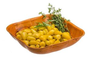 Marinated pepper in a bowl on white background photo