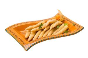 Baby corn in a bowl on white background photo