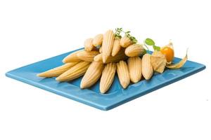 Baby corn on the plate and white background photo