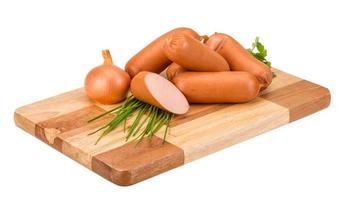 Sausages on wooden board and white background photo