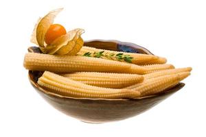 Baby corn in a bowl on white background photo