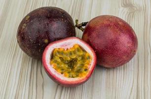 Passion fruit on wooden background photo