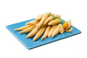 Baby corn on the plate and white background photo