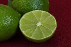 Fresh lime on red background photo