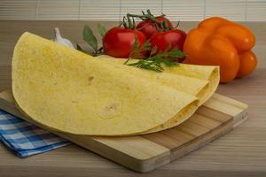 Tortilla on wooden board and wooden background photo