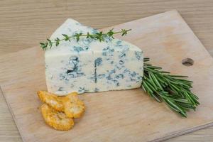 Blue cheese on wooden board and wooden background photo